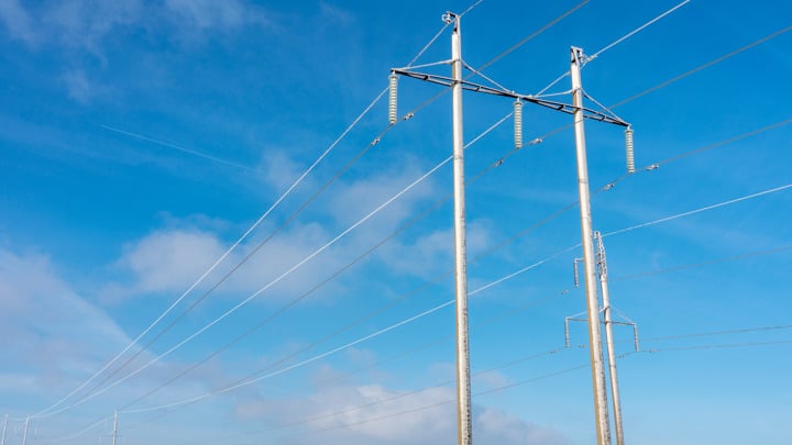 power wiring against blue sky during winter